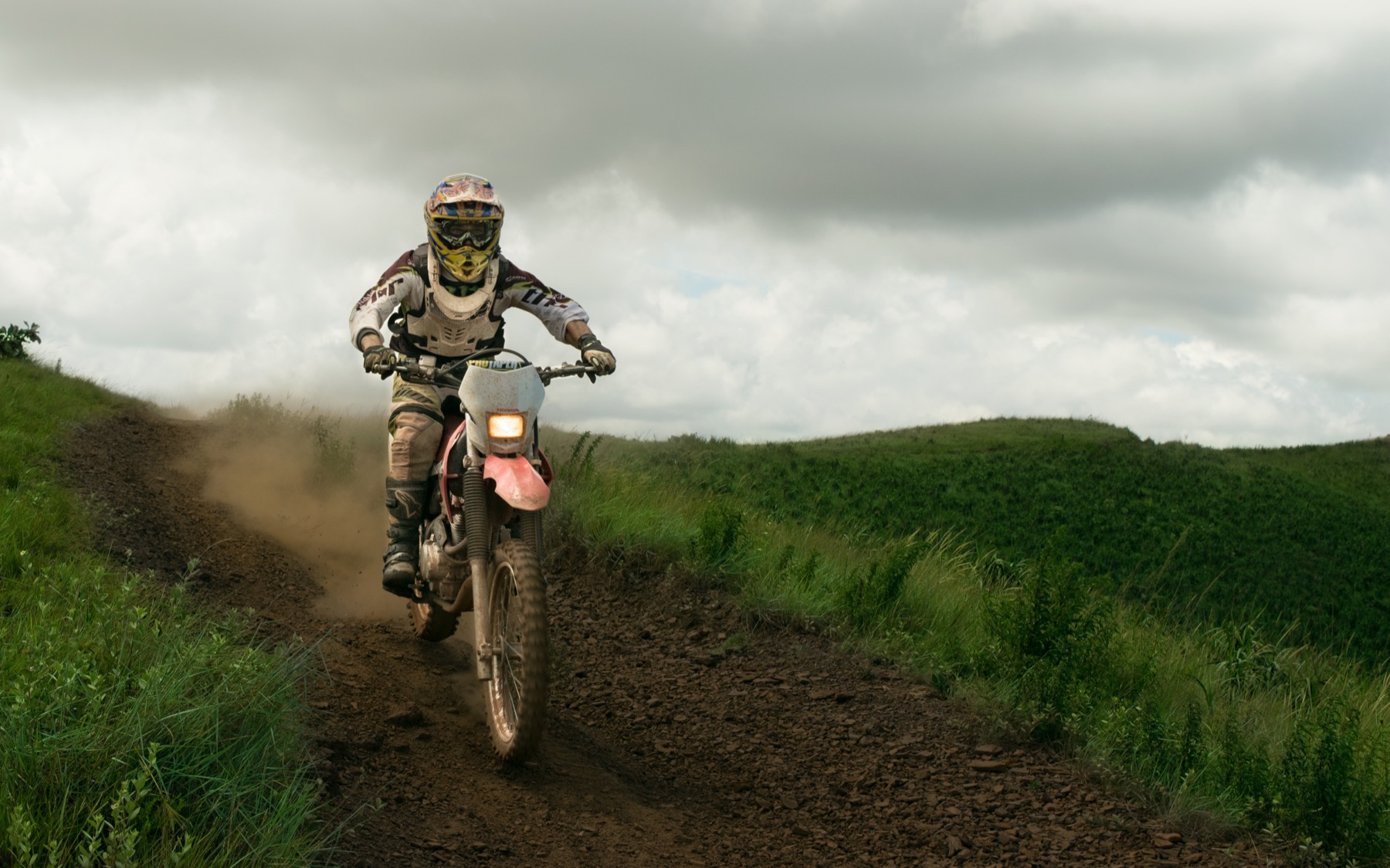 Motorbike crossing a quiet dirt road